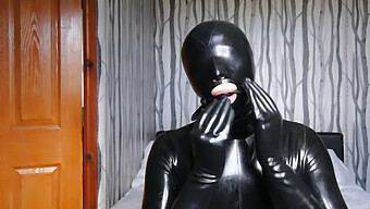 Latex-Clad Figure Restrained And Silenced In Rubber Fetish Play